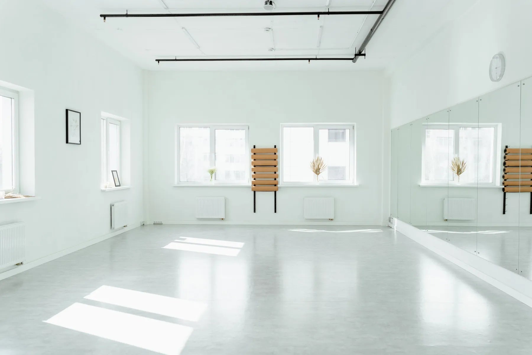 A bright empty studio with mirrors and sunlight