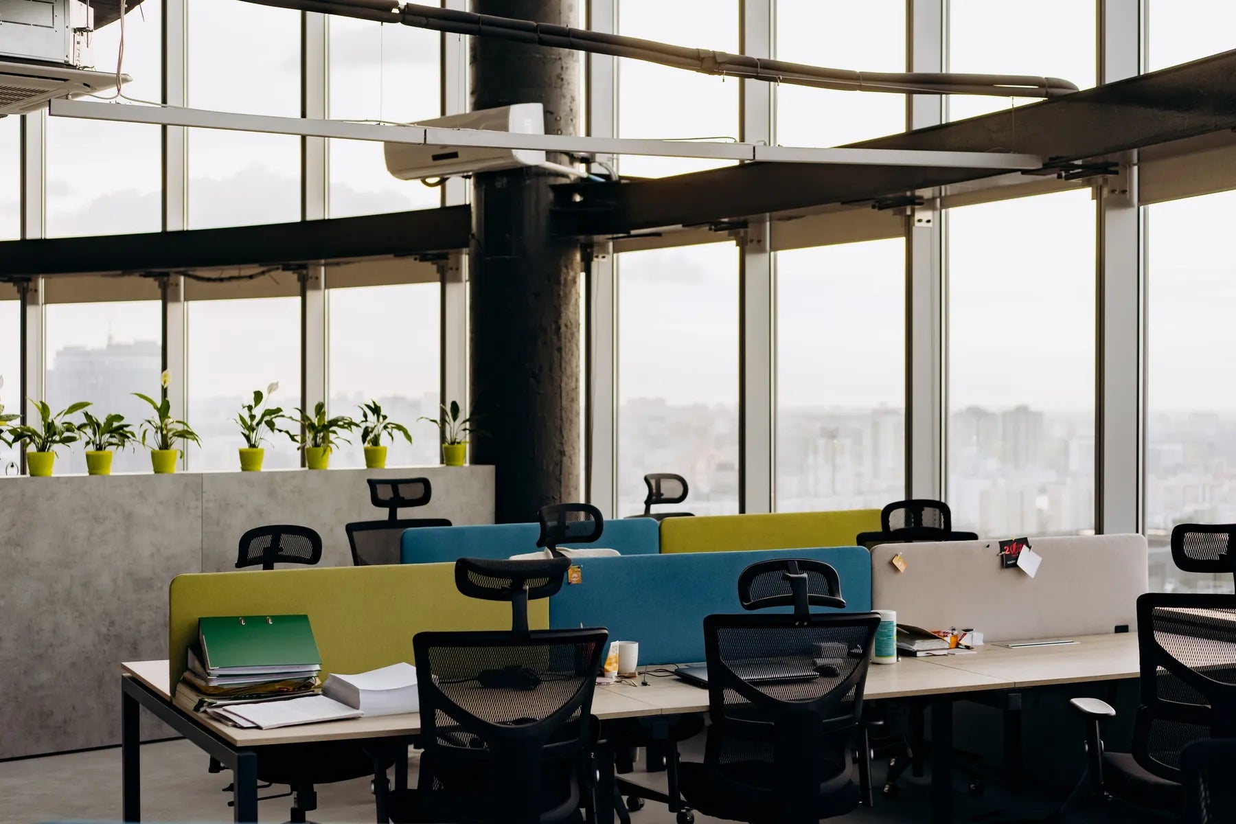 An open office with large windows and a city view