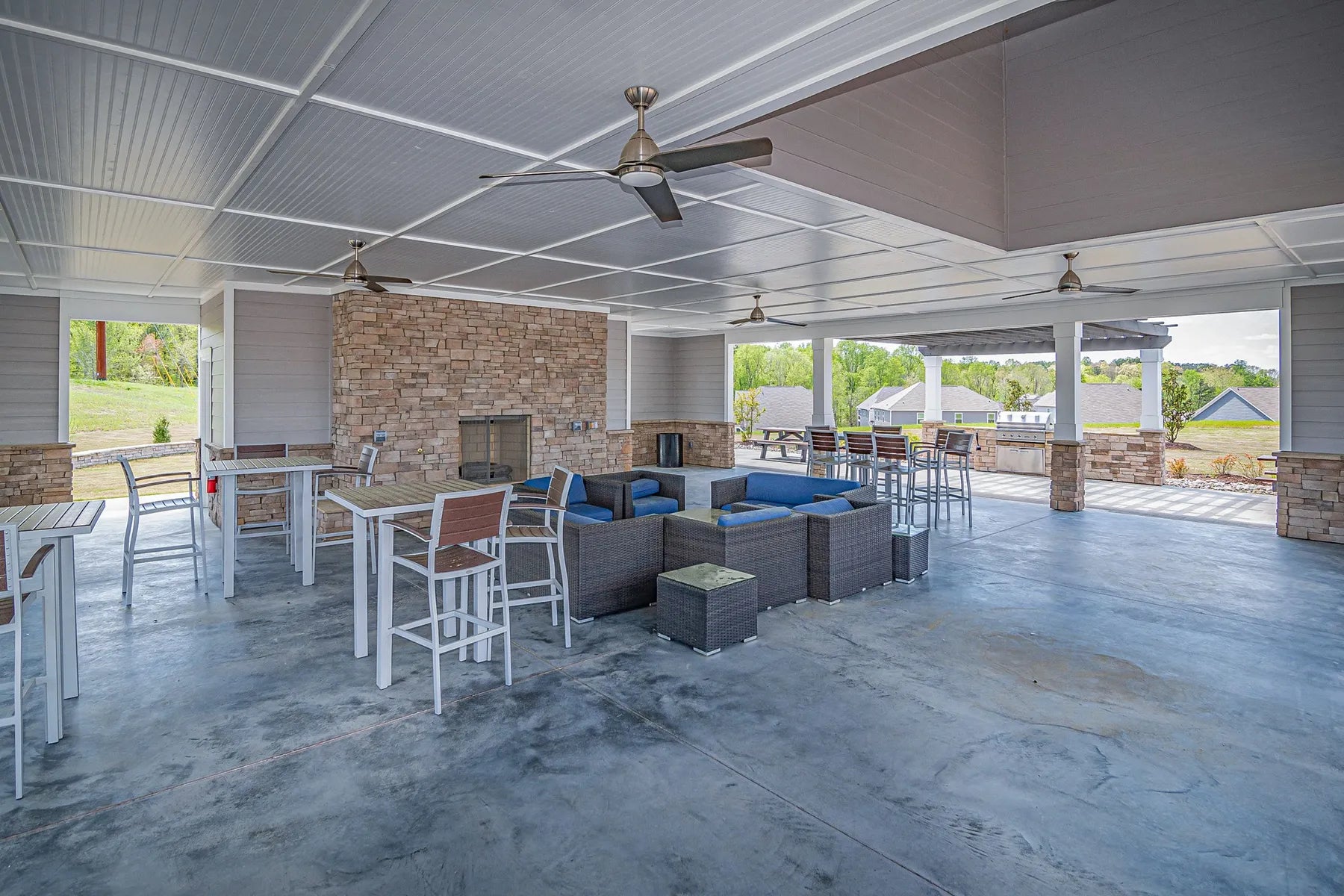 A clubhouse patio lounge with ceiling fans